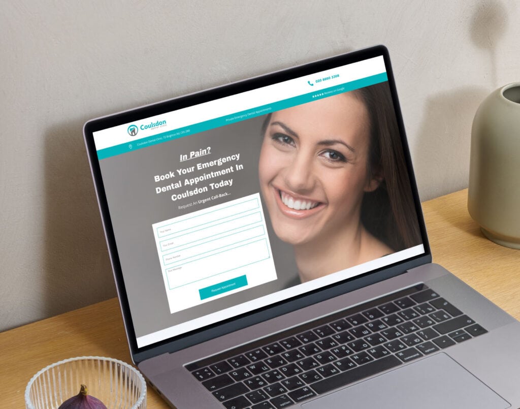 Laptop on a desk displaying a dental appointment booking page with a smiling woman's image in the background.