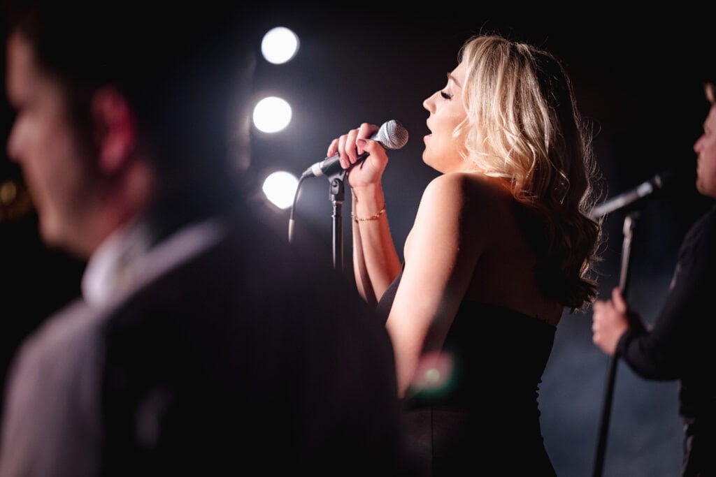 Female singer on stage in front of lights